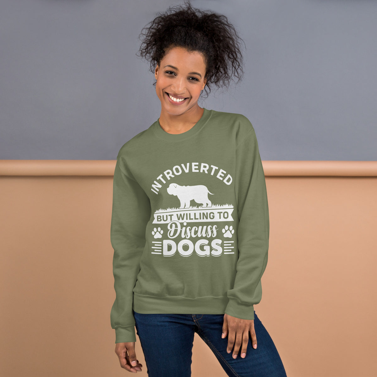 Model wearing a sweatshirt in Military Green with a white dog silhouette and Introverted But Willing to Discuss Dogs lettering