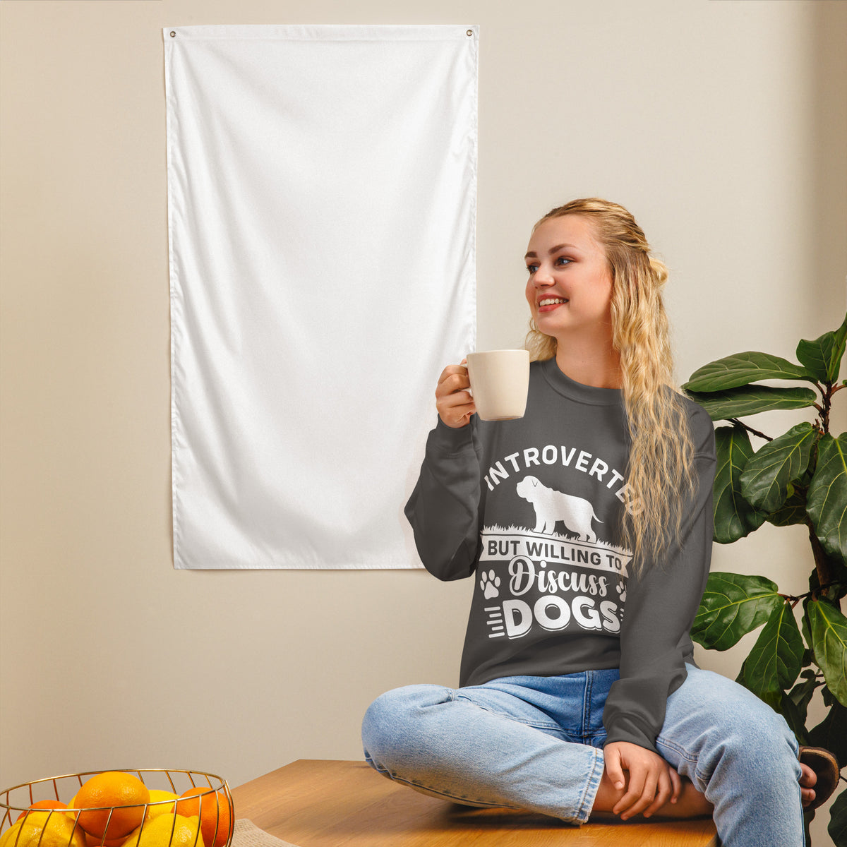 Model wearing a sweatshirt in Charcoal with a white dog silhouette and Introverted But Willing to Discuss Dogs lettering