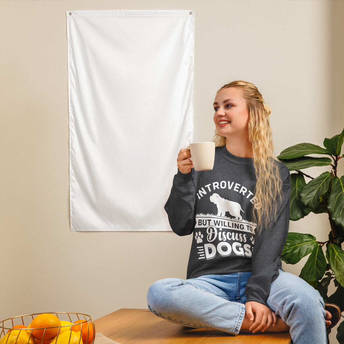 Model wearing a sweatshirt in Dark Heather with a white dog silhouette and Introverted But Willing to Discuss Dogs lettering