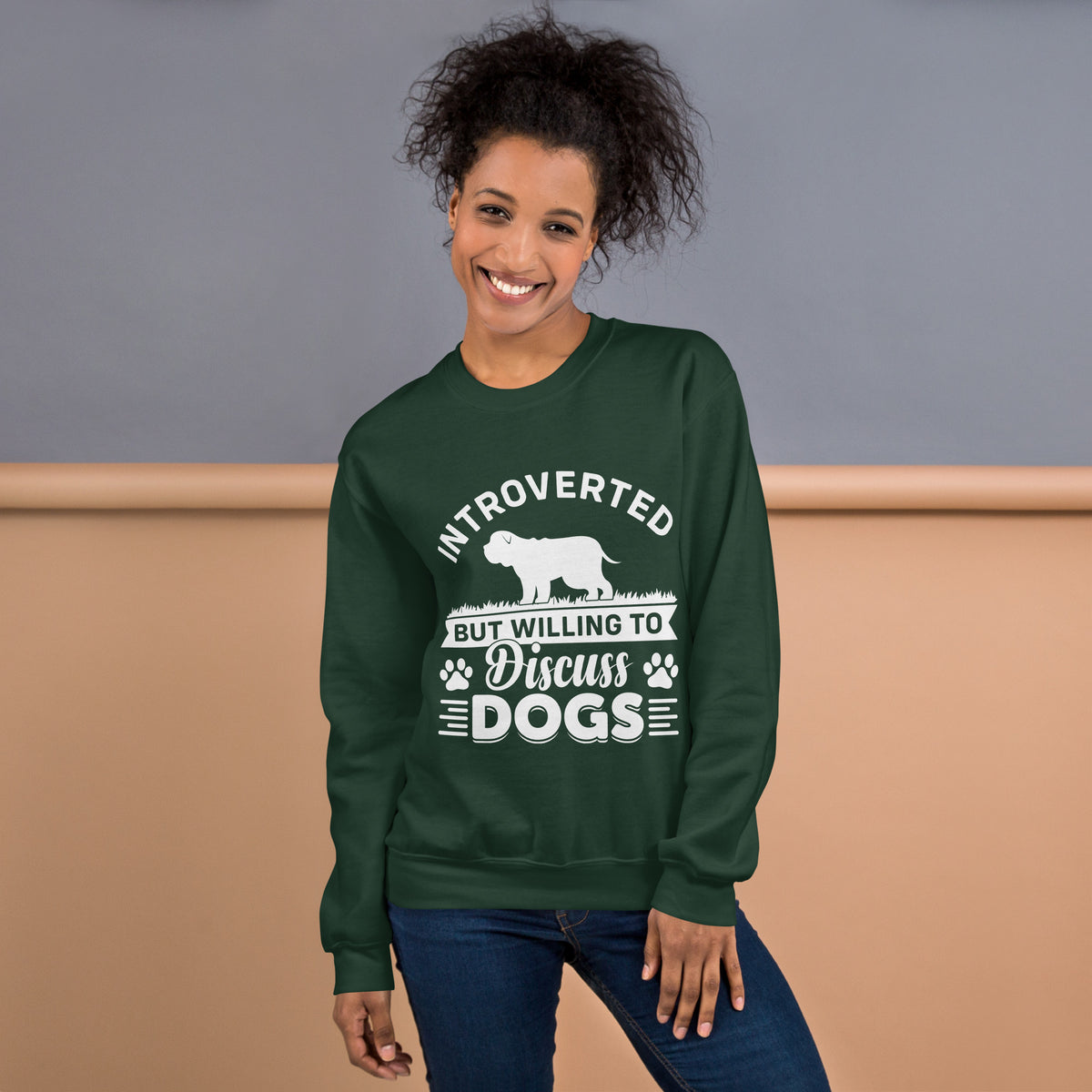 Model wearing a sweatshirt in Forest Green with a white dog silhouette and Introverted But Willing to Discuss Dogs lettering