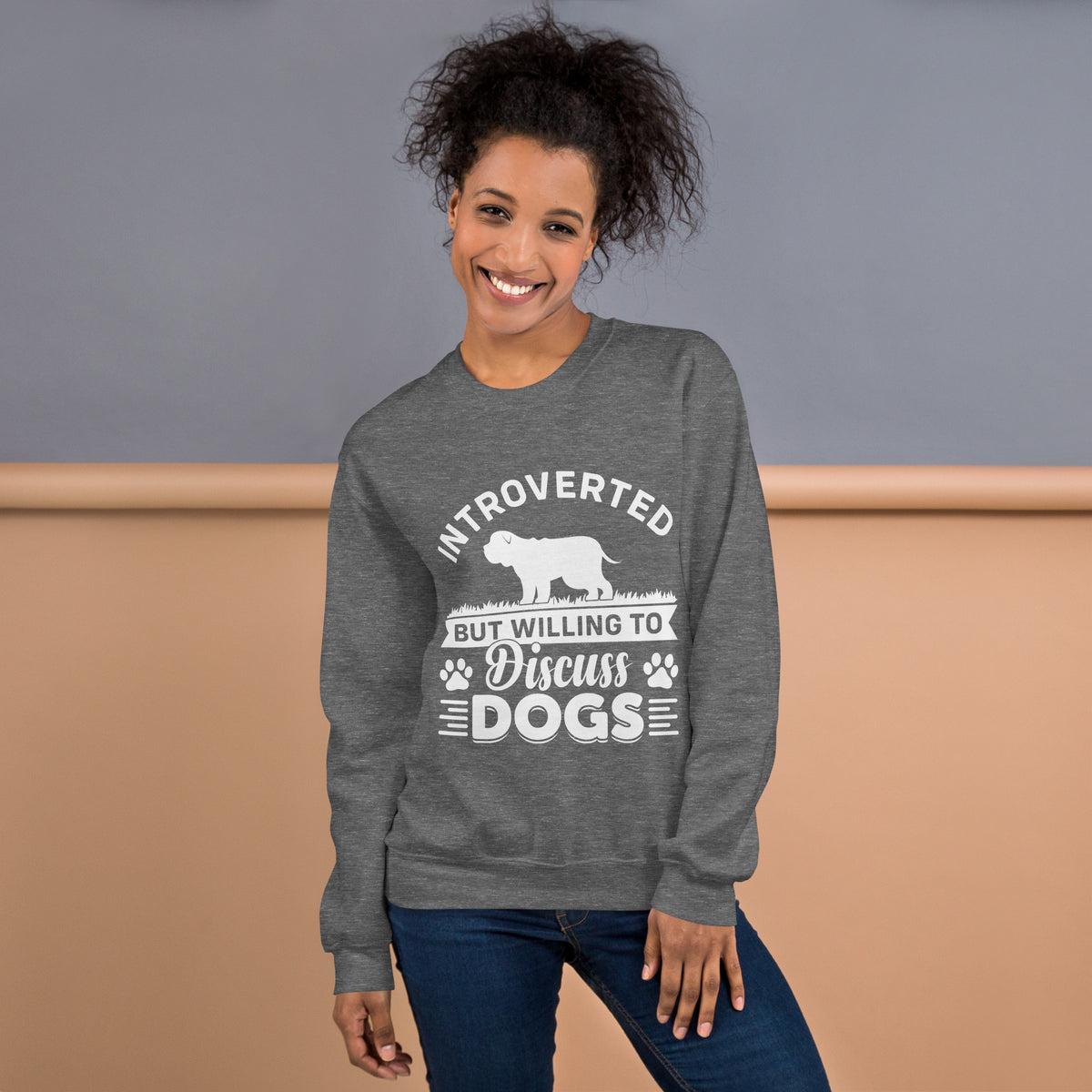 Model wearing a sweatshirt in Graphite Heather with a white dog silhouette and Introverted But Willing to Discuss Dogs lettering