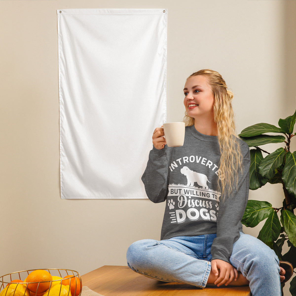 Model wearing a sweatshirt in Graphite Heather with a white dog silhouette and Introverted But Willing to Discuss Dogs lettering