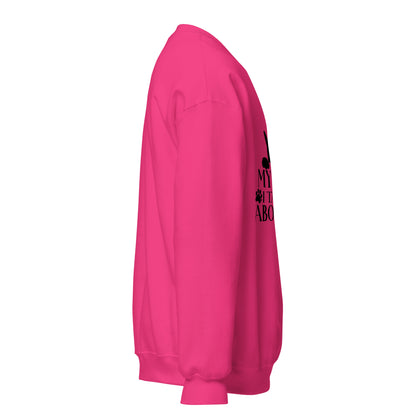 Side view of a sweatshirt in Heliconia with part of the black cat chest graphic visible