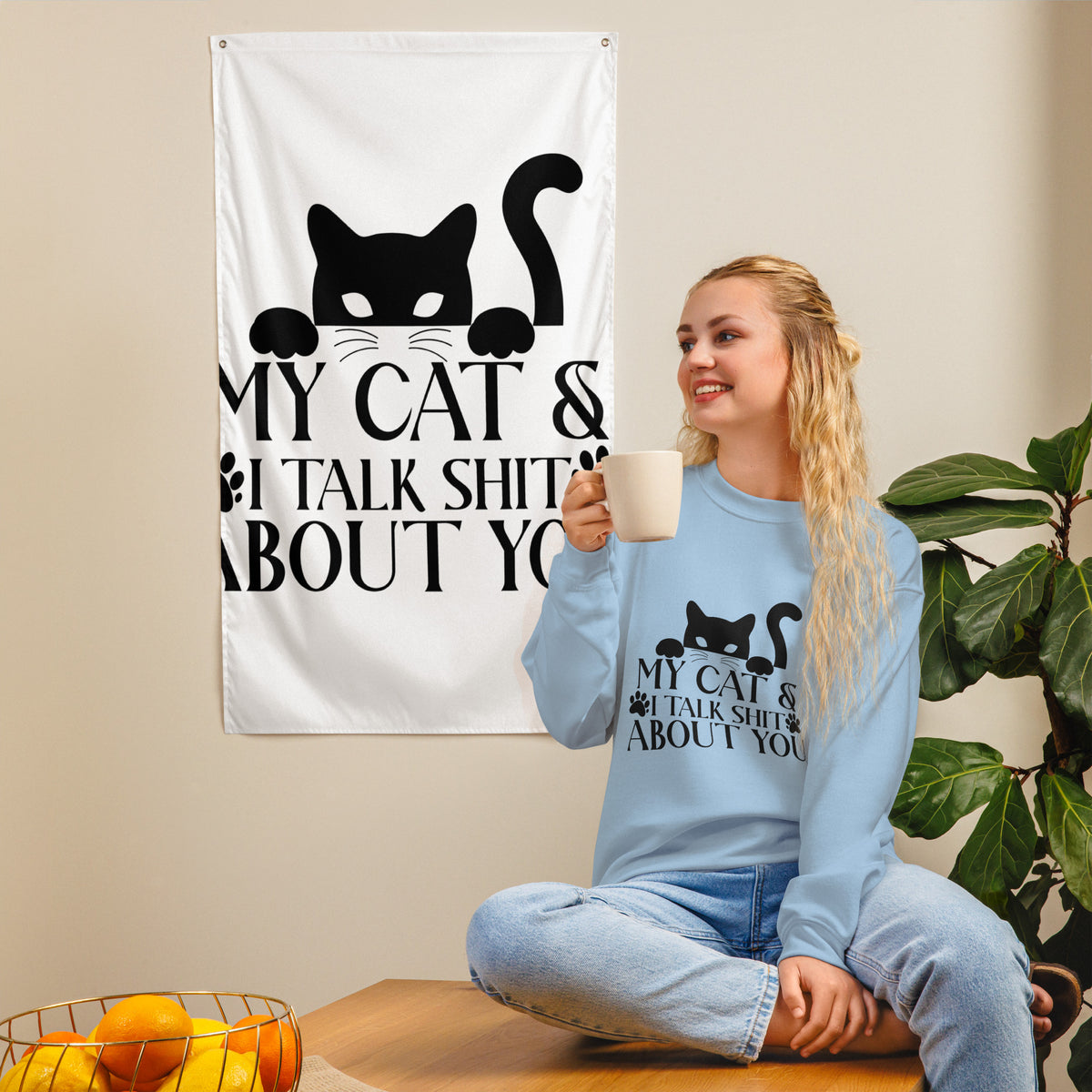 Model wearing a sweatshirt in Light Blue with a black cat graphic and My Cat and I Talk Shit About You lettering