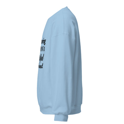 Side view of a sweatshirt in Light Blue with part of the memorial chest print visible