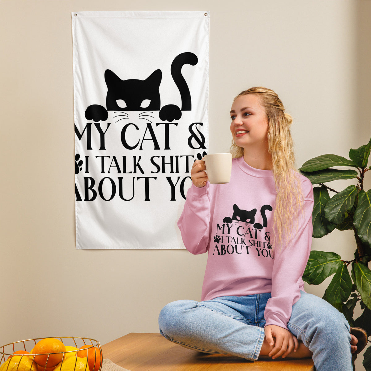 Model wearing a sweatshirt in Light Pink with a black cat graphic and My Cat and I Talk Shit About You lettering