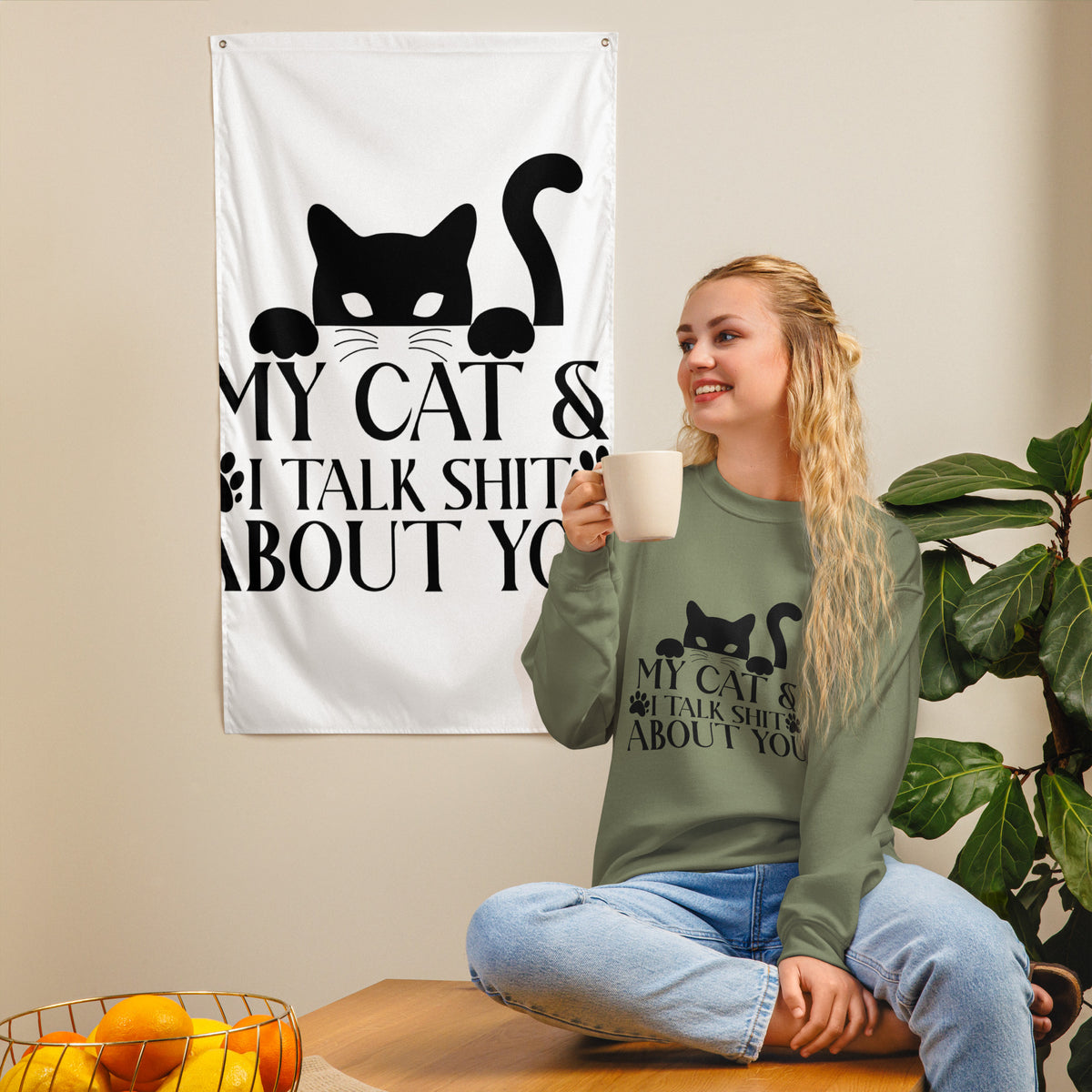 Model wearing a sweatshirt in Military Green with a black cat graphic and My Cat and I Talk Shit About You lettering
