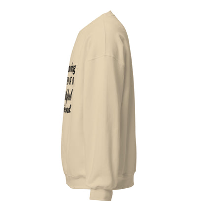 Side view of a sweatshirt in Sand with part of the memorial chest print visible